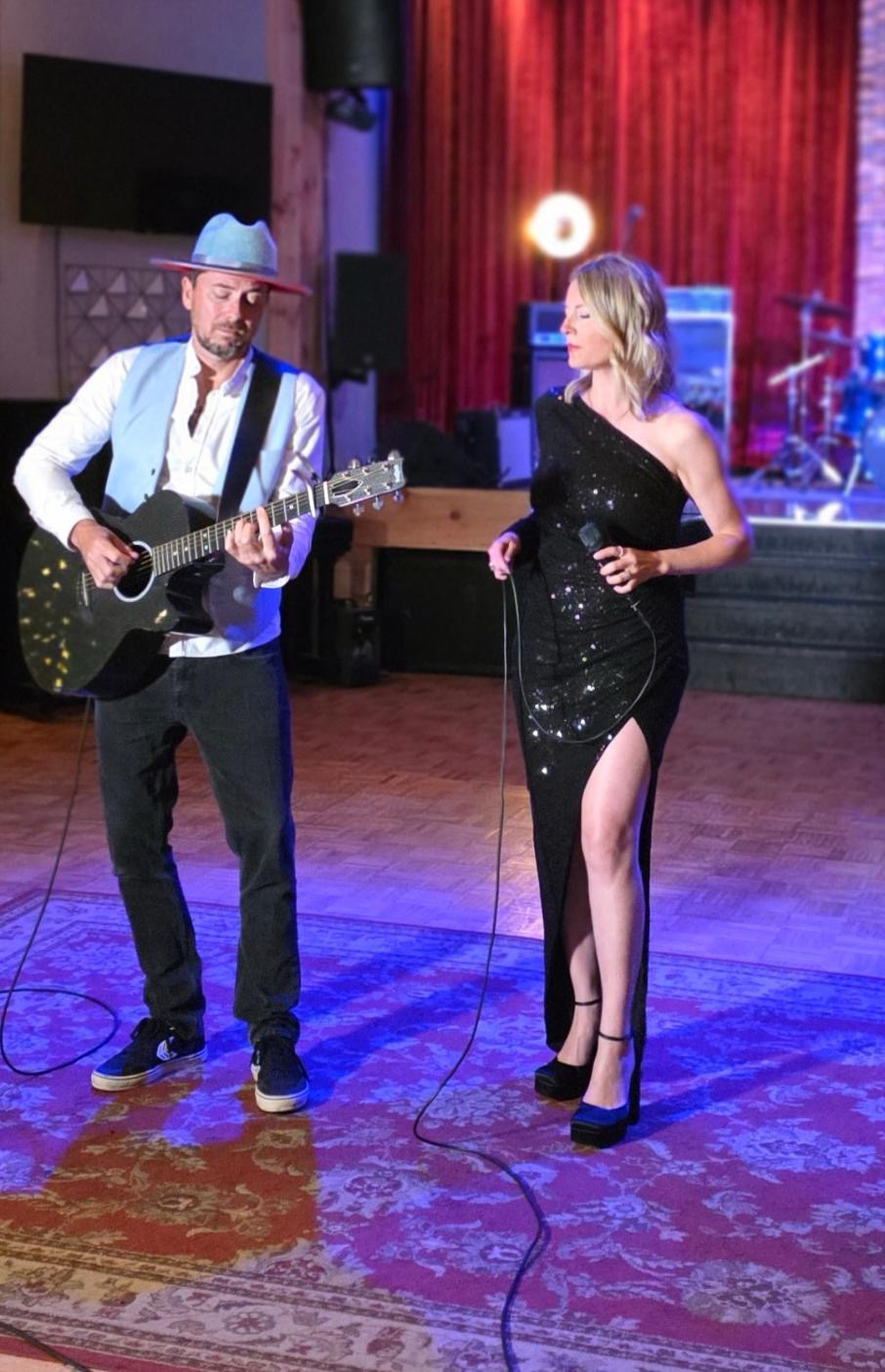 Mia and Alex performing together at an evening event